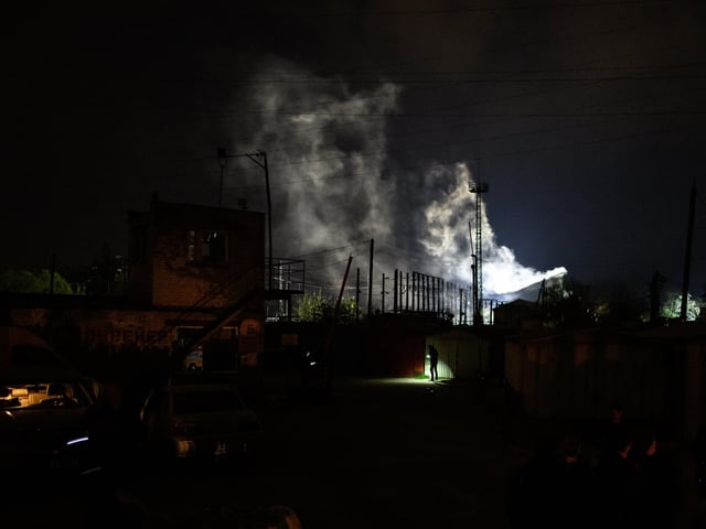 Police officers search the surrounding area as fire and smoke are seen following explosions after a Russian missile strike on May 3, 2022 in Lviv, Ukraine. Photo by Leon Neal/Getty Images