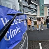 Members of the public queue for vaccinations on a vaccination bus at West College Scotland Clydebank Campus on December 17, 2021 in Glasgow, Scotland. Photo by Jeff J Mitchell/Getty Images