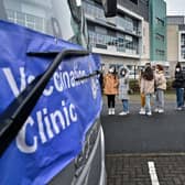 Members of the public queue for vaccinations on a vaccination bus at West College Scotland Clydebank Campus on December 17, 2021 in Glasgow, Scotland. Photo by Jeff J Mitchell/Getty Images