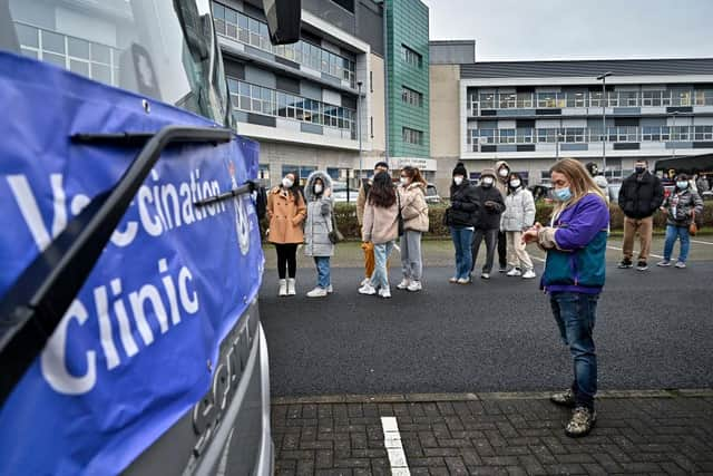 Members of the public queue for vaccinations on a vaccination bus at West College Scotland Clydebank Campus on December 17, 2021 in Glasgow, Scotland. Photo by Jeff J Mitchell/Getty Images