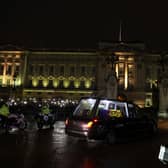 The hearse carrying the coffin of Queen Elizabeth II arrives at Buckingham Palace, London, where it will lie at rest overnight in the Bow Room. Picture date: Tuesday September 13, 2022.