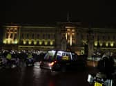 The hearse carrying the coffin of Queen Elizabeth II arrives at Buckingham Palace, London, where it will lie at rest overnight in the Bow Room. Picture date: Tuesday September 13, 2022.