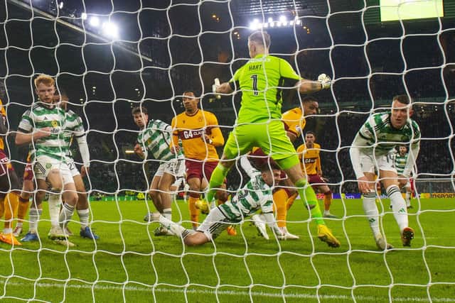 Motherwell's Jonathan Obika scores a late leveller at Celtic Park.