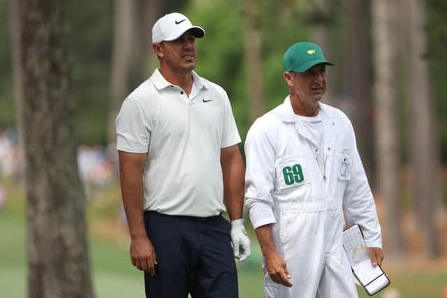 Brooks Koepka talks with his caddie Ricky Elliott on the 17th hole during the second round of the 2023 Masters at Augusta National Golf Club. Picture: Patrick Smith/Getty Images.