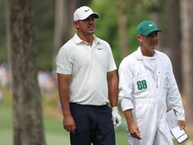 Brooks Koepka talks with his caddie Ricky Elliott on the 17th hole during the second round of the 2023 Masters at Augusta National Golf Club. Picture: Patrick Smith/Getty Images.