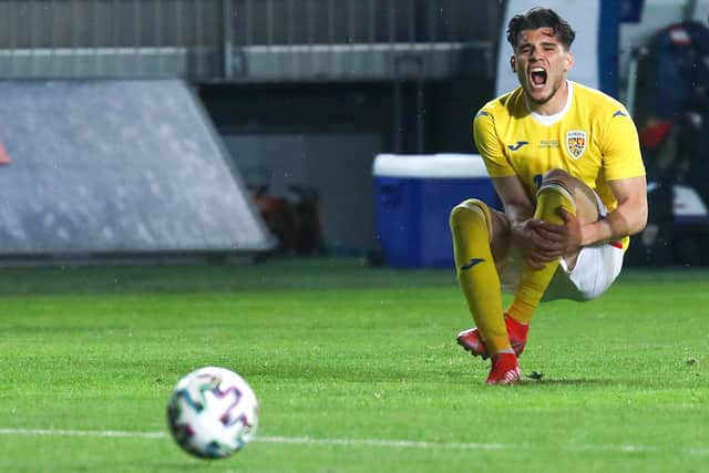 Ianis Hagi reacts after taking a painful knock during Romania's match against Georgia in Ploiesti on Wednesday night. (Photo by Vasile Mihai-Antonio/Getty Images)