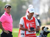 Rory McIlroy and caddie Harry Diamond look on during day one of the Abu Dhabi HSBC Championship at Abu Dhabi Golf Club. Picture: Ross Kinnaird/Getty Images.