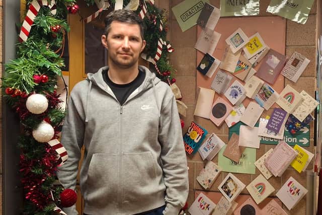 Scott Gold, 37, beside the 'thank you' wall in the neurorehabilitation unit at NHS Greater Glasgow and Clyde. Picture: NHS Greater Glasgow and Clyde/PA Wire