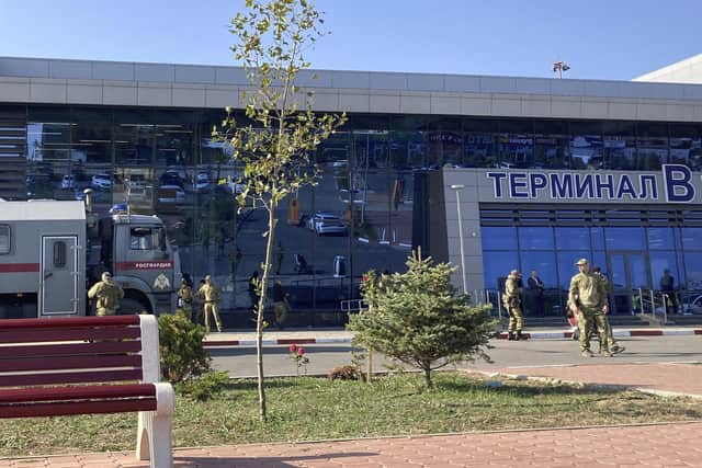 Law enforcement officers patrol an area outside the airport in Makhachkala, Dagestan. Russian police on October 30, 2023 said they had arrested 60 people suspected of storming an airport in the Muslim-majority Caucasus republic of Dagestan, seeking to attack Jewish passengers coming from Israel.