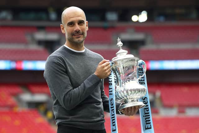 Pep Guardiola with the FA Cup trophy following Manchester City's victory over Watford in the Wembley final of 2019. (Photo by Julian Finney/Getty Images)