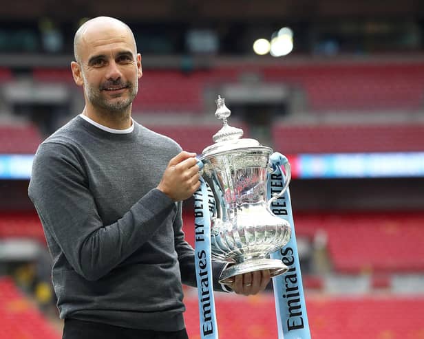 Pep Guardiola with the FA Cup trophy following Manchester City's victory over Watford in the Wembley final of 2019. (Photo by Julian Finney/Getty Images)