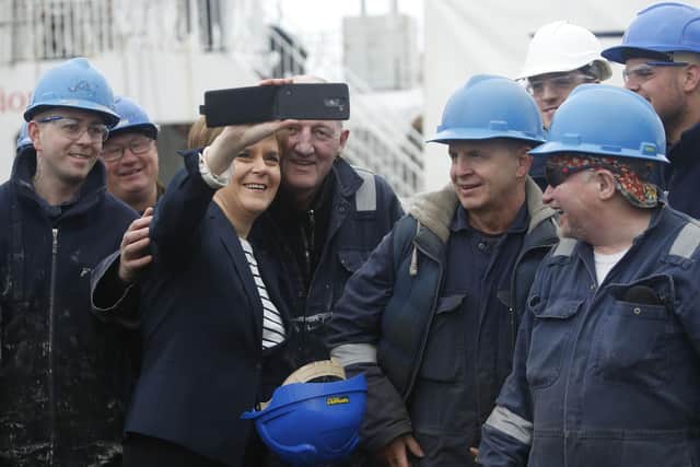 Nicola Sturgeon takes a selfie with workers during a visit to the Ferguson shipyard in Port Glasgow (Picture: Danny Lawson/PA Wire)