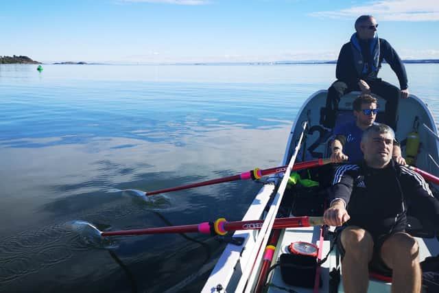 Cal MacAninch takes a break from the oars