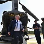 Prime Minister Boris Johnson disembarks from an Indian military Chinook helicopter upon his arrival in Gandhinagar, during his two day trip to India