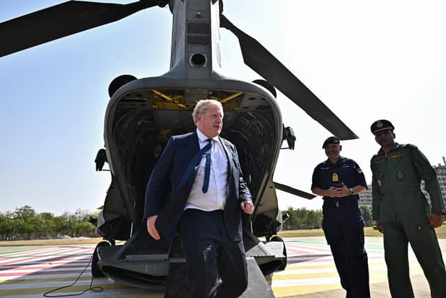 Prime Minister Boris Johnson disembarks from an Indian military Chinook helicopter upon his arrival in Gandhinagar, during his two day trip to India