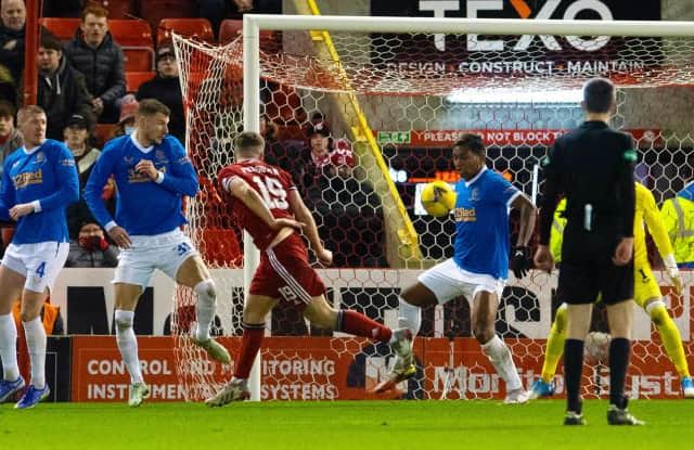 Lewis Ferguson's header struck the left arm of Rangers striker Alfredo Morelos to earn the penalty kick which secured a 1-1 draw for Aberdeen. (Photo by Ross Parker / SNS Group)