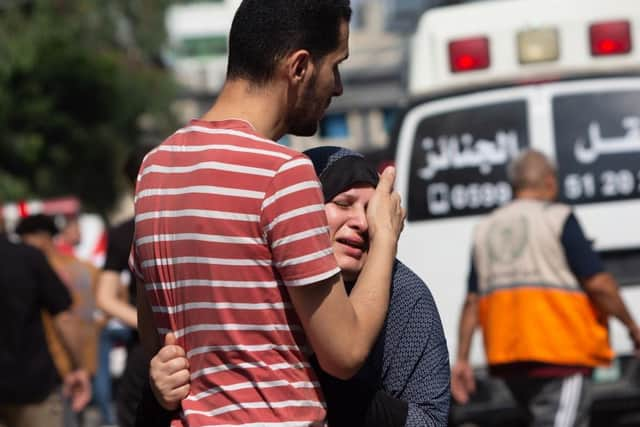 A woman cries during a funeral procession at Al-Shifa Hospital in Gaza City, Gaza.