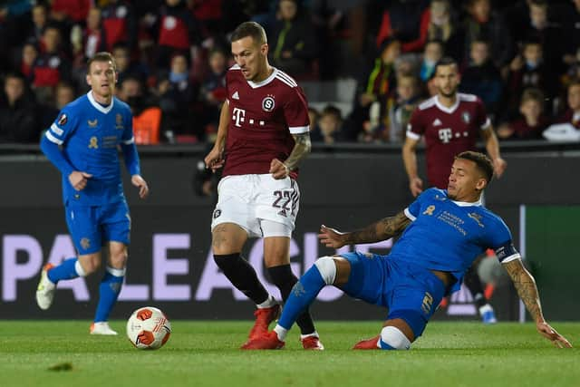 Rangers captain James Tavernier slides in to challenge Sparta Prague's Lukas Haraslin during the Europa League match at the Letna Stadium. (Photo by MICHAL CIZEK/AFP via Getty Images)