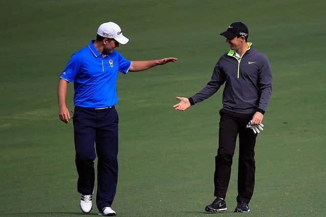 Rory McIlroy congratulates Bradley Neil the Scot had chipped in from the fairway during a practice round for the 2015 Masters. Picture: Jamie Squire/Getty Images.