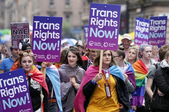 People carrying Trans rights banners taking part in the Pride Glasgow parade.