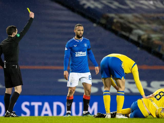 Kemar Roofe is booked by David Munro for the challenge on Murray Davidson