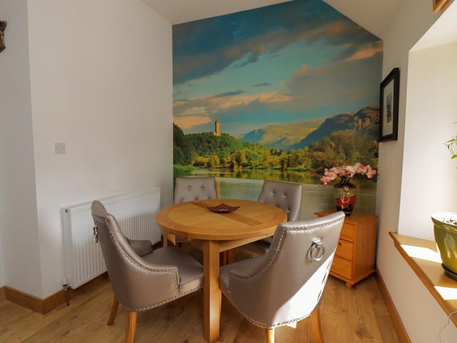 Roman Road, West Plean - dining area with feature wall art of the Wallace Monument.