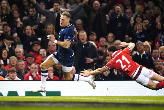 Scotland's Duhan van der Merwe (left) gets past Wales' Tomos Williams to score his side's third try of the game during the Guinness Six Nations match at the Principality Stadium, Cardiff. Picture date: Saturday February 3, 2024.