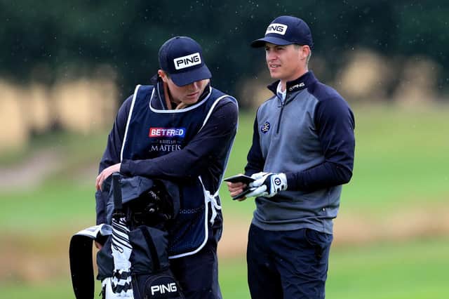 Calum Hill, right, talks tactics with his caddie, brother Ian, during the second round of the Betfred British Masters at Close House, near Newcastle. Picture: Mike Egerton/PA