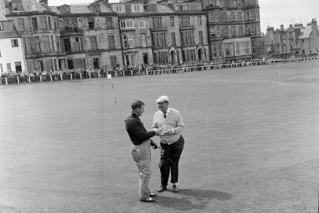 Four-time winner Bobby Locke congratulating playing partner Christy O'Conner on the 18th green during the 1964 Open Championship. O'Connor led after the first round but ended up tied for sixth.