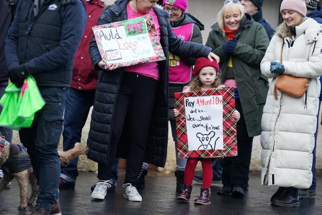 Kate Limardi with her daughter Ella, joins striking teachers from the EIS to gather on the anniversary of Robert Burns' birth in 1759 outside the cottage in Alloway, Ayrshire, where he was born, as a rolling programme of regional action reaches its halfway point, with teachers in both South Ayrshire and Edinburgh taking strike action in a dispute over pay.