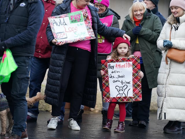 Kate Limardi with her daughter Ella, joins striking teachers from the EIS to gather on the anniversary of Robert Burns' birth in 1759 outside the cottage in Alloway, Ayrshire, where he was born, as a rolling programme of regional action reaches its halfway point, with teachers in both South Ayrshire and Edinburgh taking strike action in a dispute over pay.
