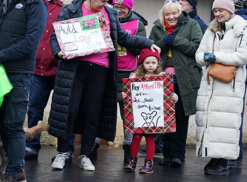Kate Limardi with her daughter Ella, joins striking teachers from the EIS to gather on the anniversary of Robert Burns' birth in 1759 outside the cottage in Alloway, Ayrshire, where he was born, as a rolling programme of regional action reaches its halfway point, with teachers in both South Ayrshire and Edinburgh taking strike action in a dispute over pay.