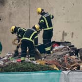 Specialist rescue teams at the scene of an explosion and fire at a block of flats in St Helier, Jersey. At least three people have died and a dozen are missing following the blast. Picture date: Sunday December 11, 2022.