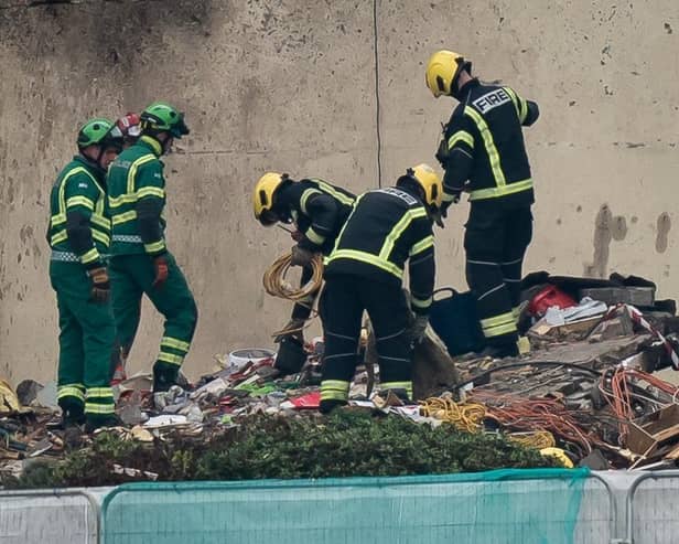 Specialist rescue teams at the scene of an explosion and fire at a block of flats in St Helier, Jersey. At least three people have died and a dozen are missing following the blast. Picture date: Sunday December 11, 2022.