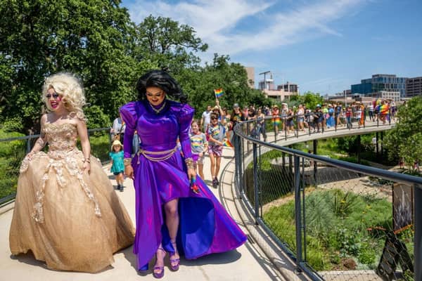 Drag queens Brigitte Bandit and Tequila Rose lead a pride parade march last year in Texas.