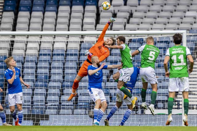 St Johnstone goalkeeper Zander Clark punches clear during the Scottish Cup final match between Hibs in May 2021.