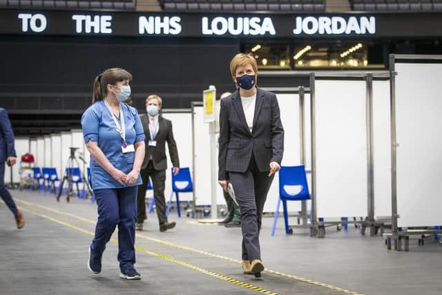 First Minister of Scotland Nicola Sturgeon after receiving the first shot of the Astra Zeneca vaccine, administered by staff nurse Elaine Anderson, at the NHS Louisa Jordan vaccine centre in the SSE Hydro in Glasgow, Scotland. Picture date: Thursday April 15, 2021.