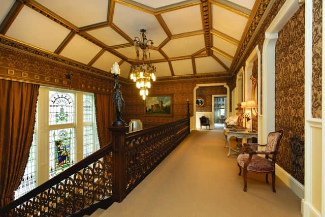 The landing overlooks a stunning stained glass window