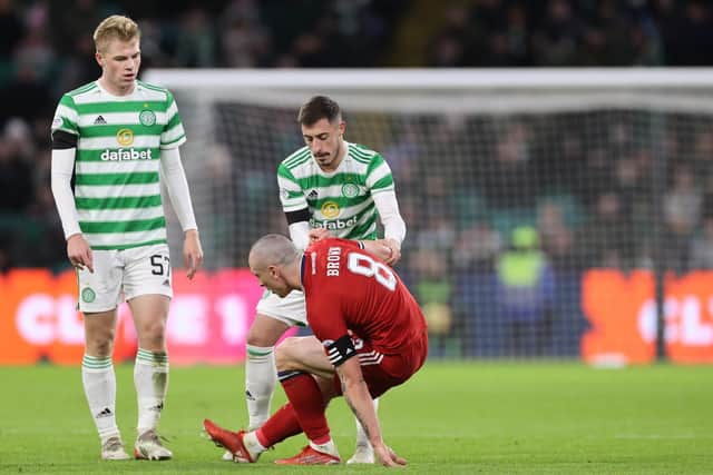 Aberdeen's Scott Brown is helped up by Celtic's Josip Juranovic during the cinch Premiership match at Celtic Park. (Steve Welsh/PA Wire)