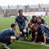 Gozie Ugwu is in there somewhere as he and his teammates celebrate his decisive goal in the 2-0 win v Dunfermline (Photo by Paul Devlin / SNS Group)