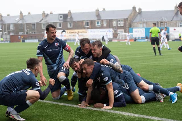 Gozie Ugwu is in there somewhere as he and his teammates celebrate his decisive goal in the 2-0 win v Dunfermline (Photo by Paul Devlin / SNS Group)