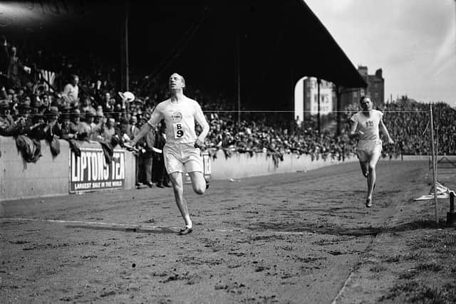 Scottish athlete Eric Liddell (1902 - 1945) wins the 1-mile relay at an International Athletics Meeting between England and America, UK, 19th July 1924.  (Photo by MacGregor/Topical Press Agency/Getty Images)