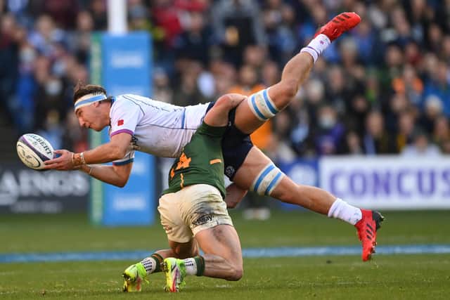 Jamie Ritchie manages to offload as he feels the full force of a tackle from South Africa wing Jesse Kriel. (Photo by Stu Forster/Getty Images)