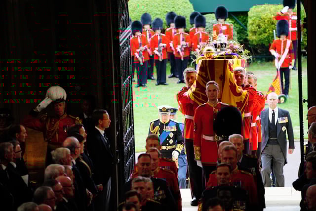 King Charles III (left) follows as coffin bearers carry the coffin of Queen Elizabeth II into St George's Chapel in Windsor Castle, Berkshire, for the Committal Service. Picture date: Monday September 19, 2022.
