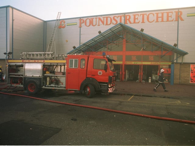 Firefighters try to dampen a fire at the Poundstretcher store at the Fort Kinnaird Retail Park on February 5 1996.