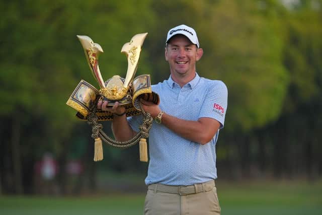 Australian Lucas Herbert poses with the trophy after winning the ISPS Handa Championship at PGM Ishioka GC. Picture: Yoshimasa Nakano/Getty Images.