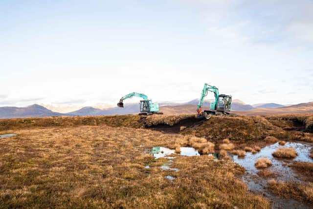 Diggers at work doing peatland restoration.