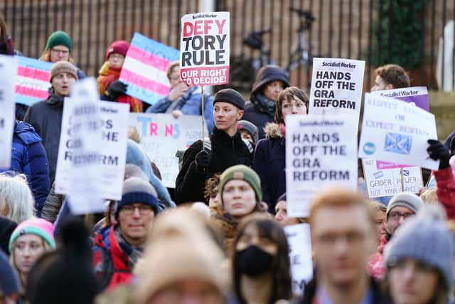 People take part in a demonstration for trans rights outside the UK Government Office at Queen Elizabeth House in Edinburgh. Picture: PA