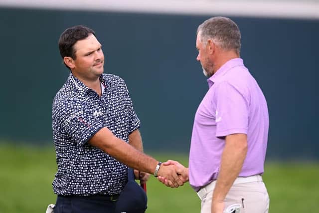 LIV Golf duo Patrick Reed shakes hands with Lee Westwood of England on the 18th hole after the final rond of the Ross Kinnaird/Getty Images.