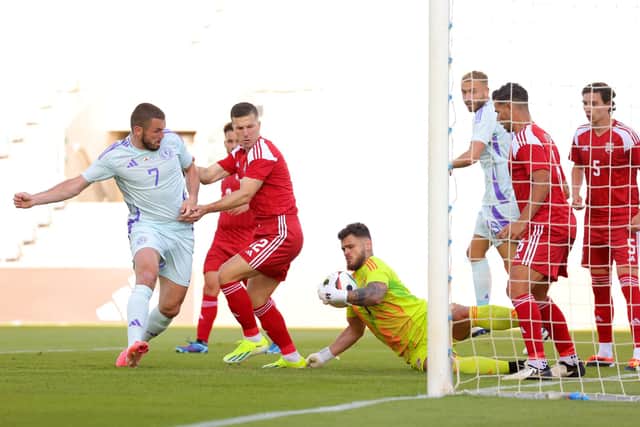 Jaylan Hankins of Gibraltar makes a save from John McGinn of Scotland.